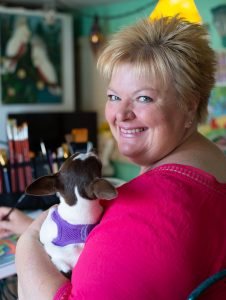 Artist Barbara Swift with her trusty sidekick CoCo.